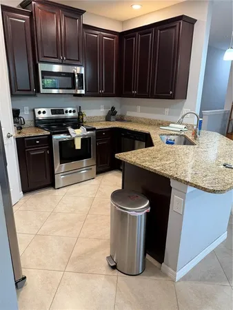 a kitchen with a sink and a stove top oven