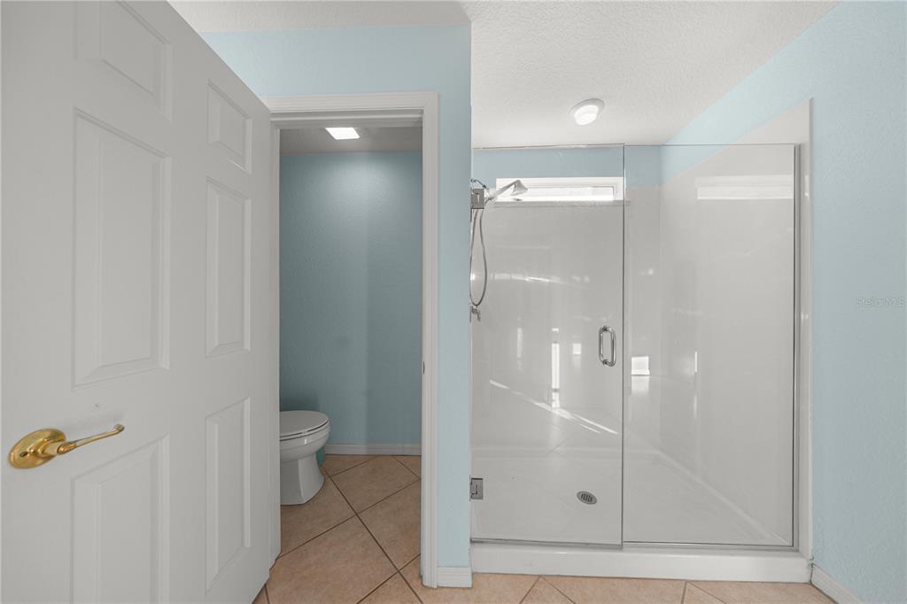 9175 Southeast 118th Loop Summerfield, FL 34491 - Photo 22 of 28 a bathroom with a shower and toilet