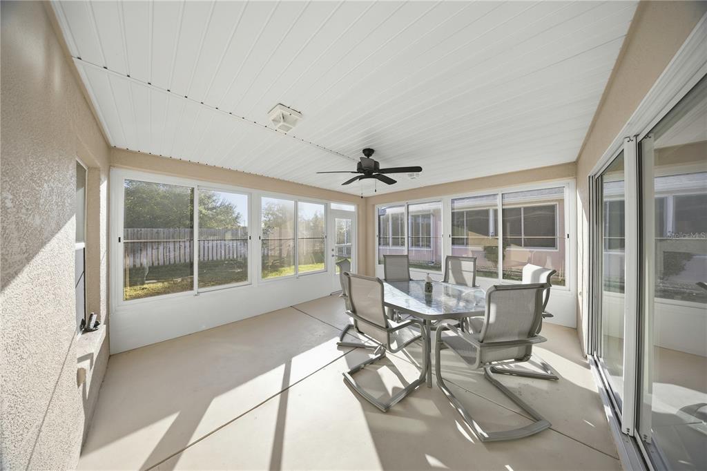 9175 Southeast 118th Loop Summerfield, FL 34491 - Photo 23 of 28 a view of a dining room with furniture large windows and wooden floor