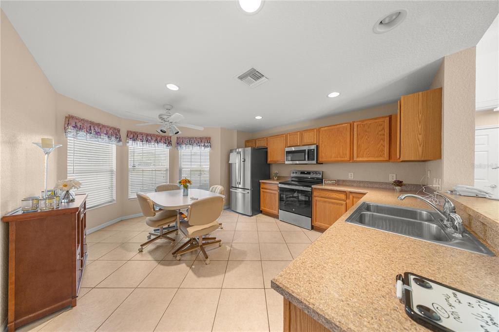 9175 Southeast 118th Loop Summerfield, FL 34491 - Photo 9 of 28 a kitchen with stainless steel appliances granite countertop a sink and a stove