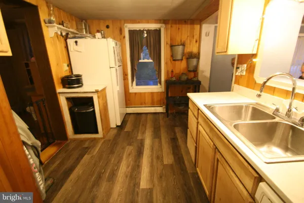 a view of a kitchen with a sink a refrigerator and a stove