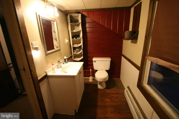 a bathroom with sink toilet and mirror