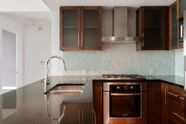a kitchen with granite countertop a stove and a sink