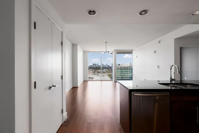 a view of a kitchen with a sink and wooden floor