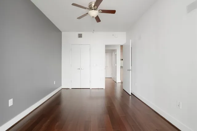 a view of an empty room with wooden floor