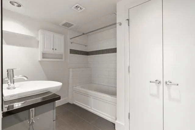 a bathroom with a bathtub and a sink