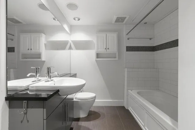 a bathroom with a sink a toilet and bathtub