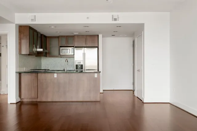 a kitchen with stainless steel appliances granite countertop a refrigerator a sink and a stove