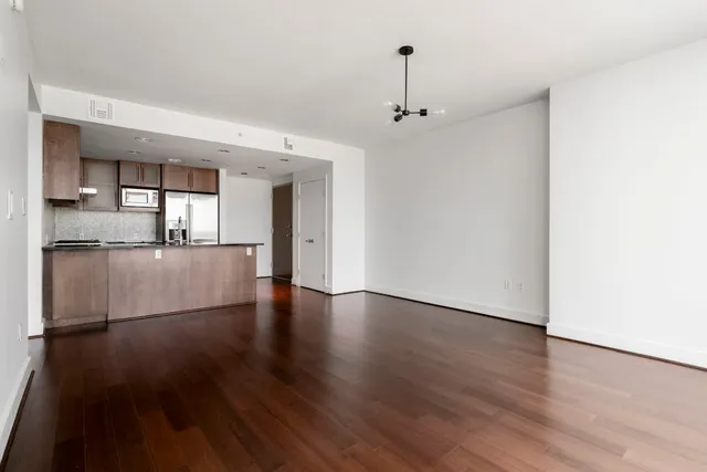 a view of a kitchen with wooden floor and a kitchen