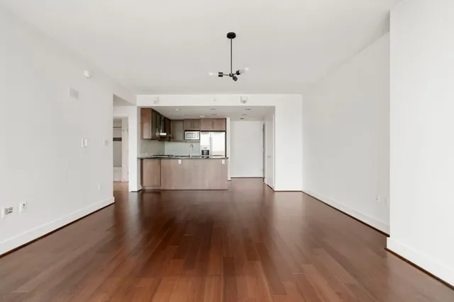 a view of a kitchen with wooden floor and a kitchen