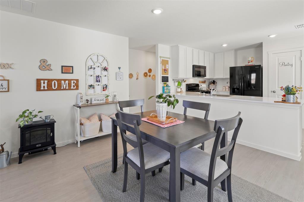 7229 Adderly Road Pilot Point, TX 76258 - Photo 12 of 34 a dining room with furniture and wooden floor