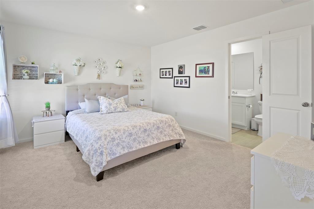 7229 Adderly Road Pilot Point, TX 76258 - Photo 18 of 34 a bedroom with a bed and a lamp