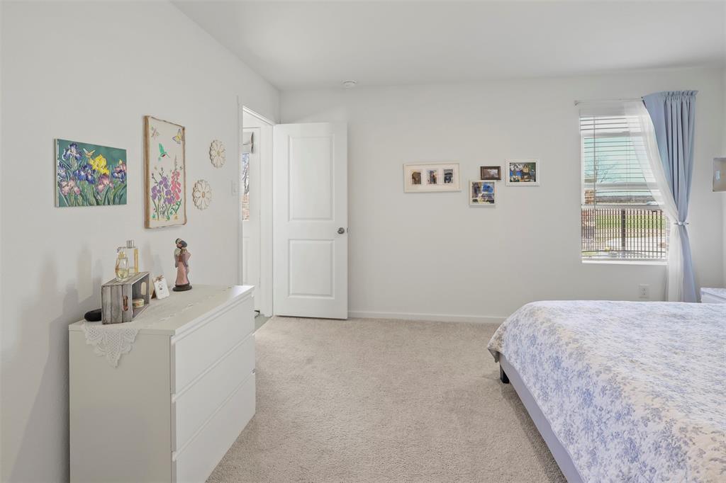 7229 Adderly Road Pilot Point, TX 76258 - Photo 19 of 34 a bedroom with a bed and a flat screen tv