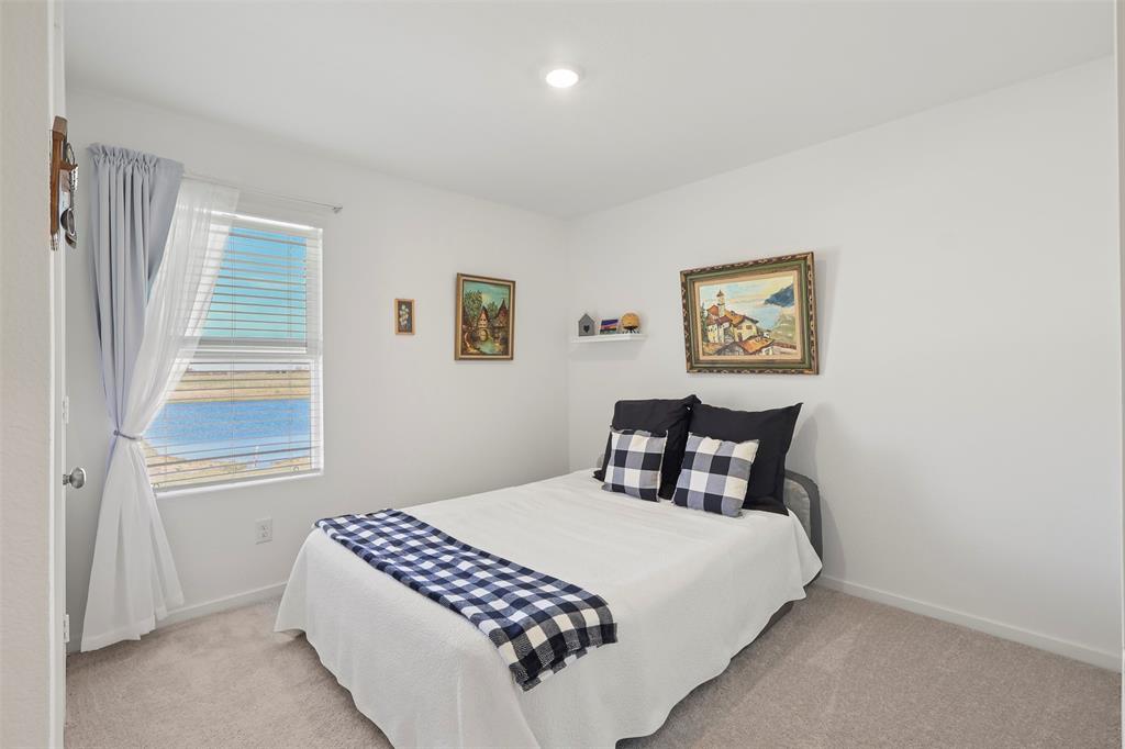 7229 Adderly Road Pilot Point, TX 76258 - Photo 21 of 34 a bedroom with a bed and a painting on the wall