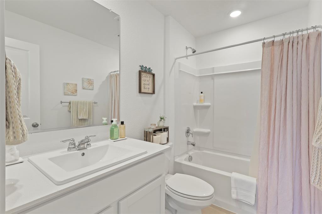 7229 Adderly Road Pilot Point, TX 76258 - Photo 22 of 34 a bathroom with a sink toilet and shower