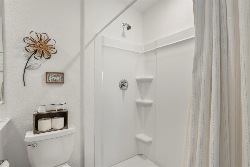 7229 Adderly Road Pilot Point, TX 76258 - Photo 24 of 34 a bathroom with a toilet and a sink