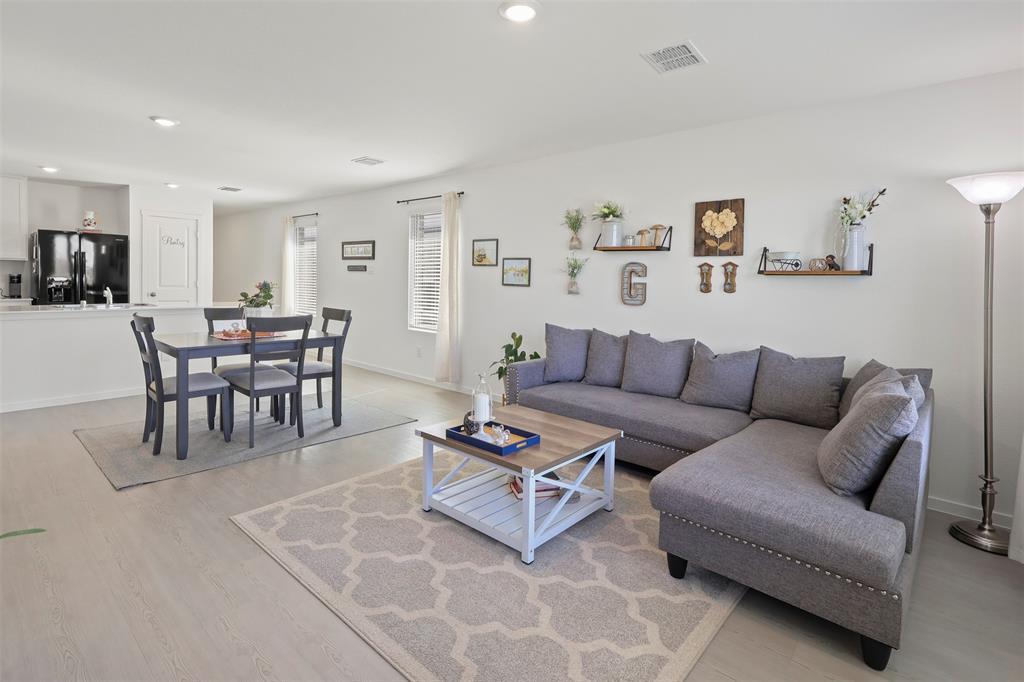 7229 Adderly Road Pilot Point, TX 76258 - Photo 8 of 34 a living room with furniture a dining table and a potted plant