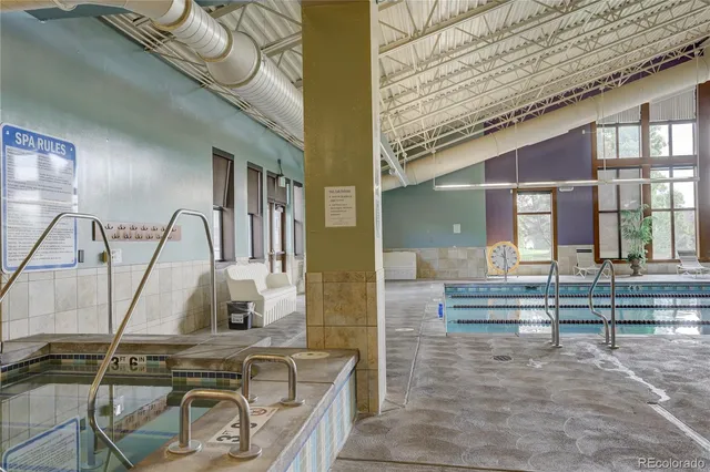 a view of a swimming pool and outdoor seating