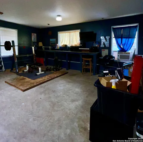 a living room with furniture a dining table and a flat screen tv
