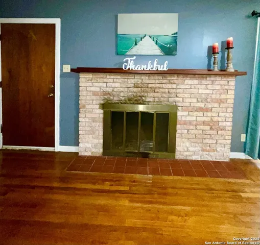 a view of a livingroom with a fireplace and a window