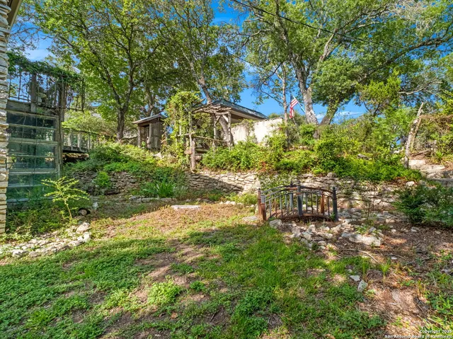 a backyard of a house with table and chairs