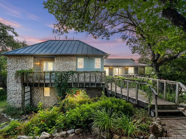 a view of a house with a yard next to a lake