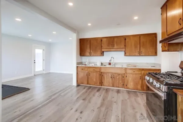 a kitchen with wooden floors and cabinets