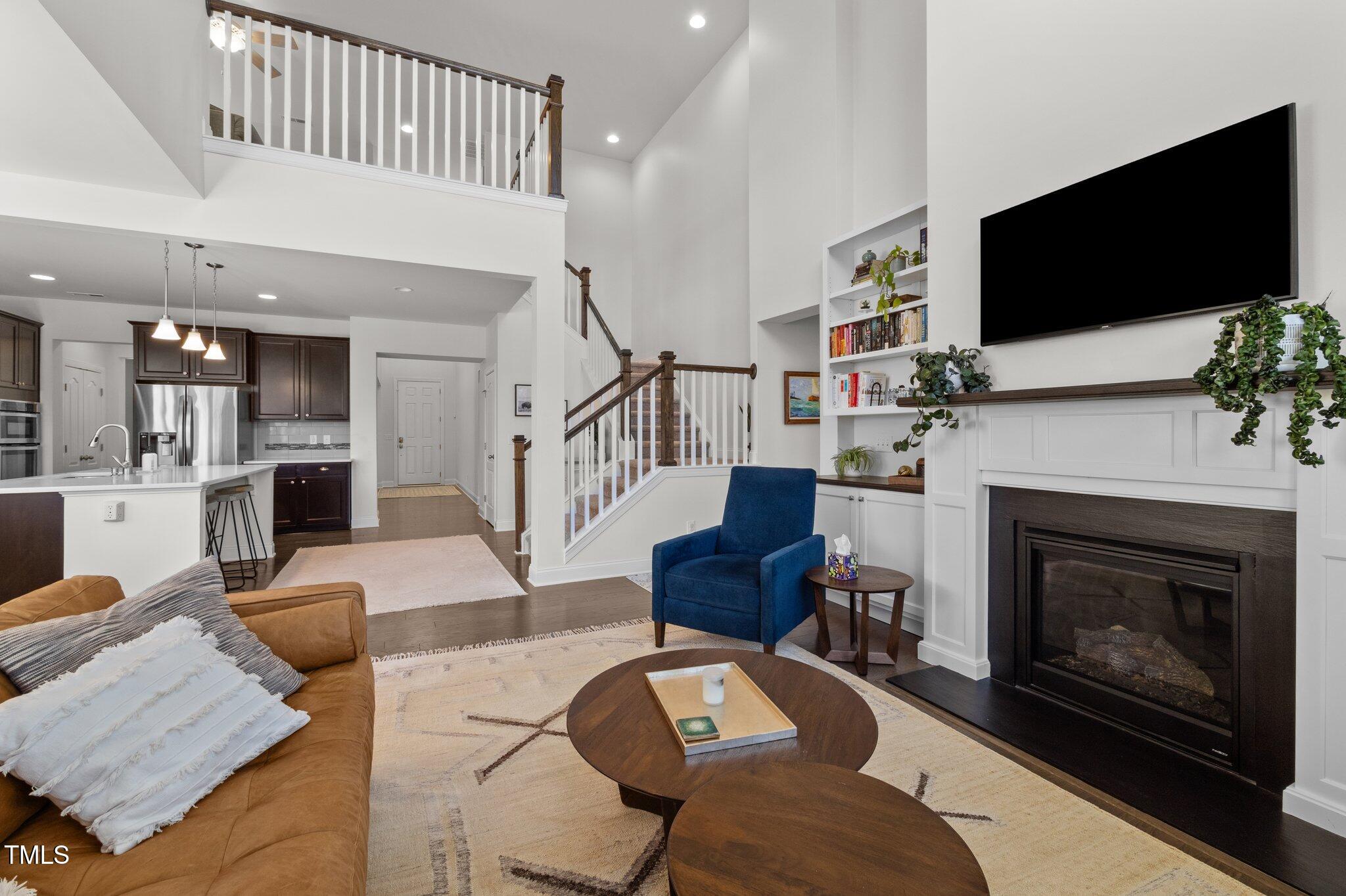 212 Crisp Road Durham, NC 27713 - Photo 12 of 36 a living room with furniture a flat screen tv and a fireplace