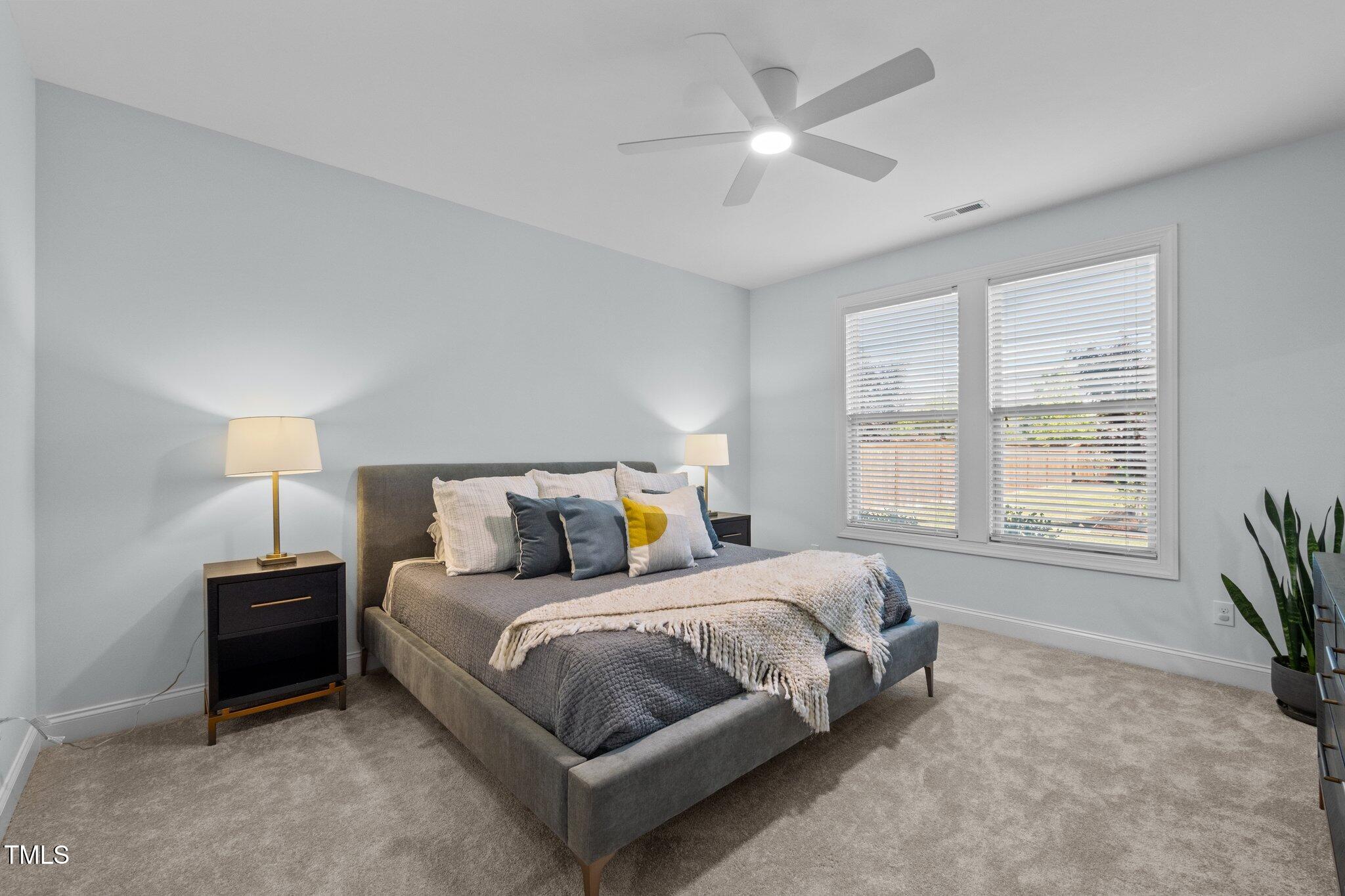 212 Crisp Road Durham, NC 27713 - Photo 14 of 36 a bedroom with a bed chandelier and a window