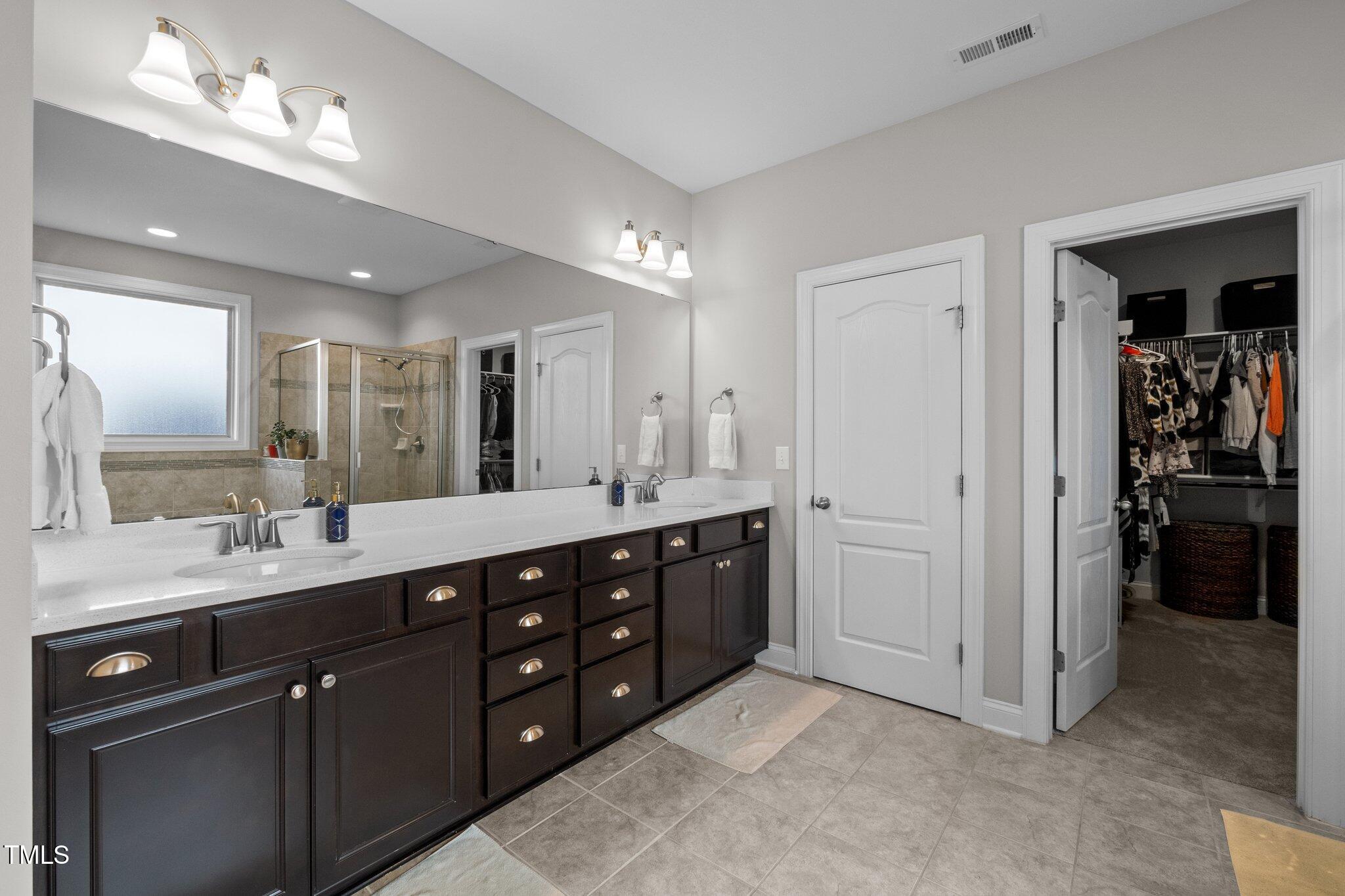 212 Crisp Road Durham, NC 27713 - Photo 16 of 36 a spacious bathroom with double vanity a double vanity and a mirror