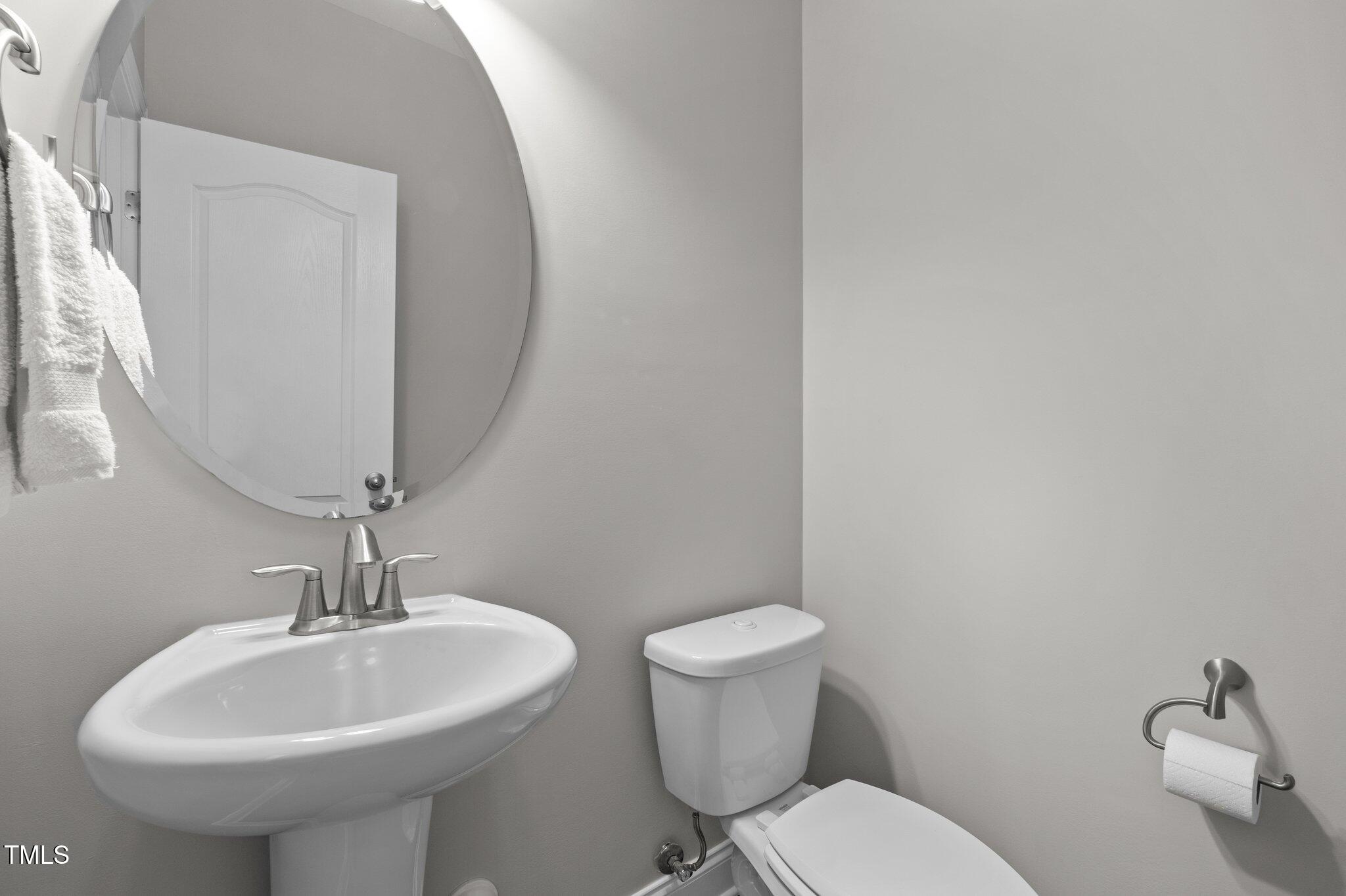 212 Crisp Road Durham, NC 27713 - Photo 19 of 36 a bathroom with a toilet sink and mirror