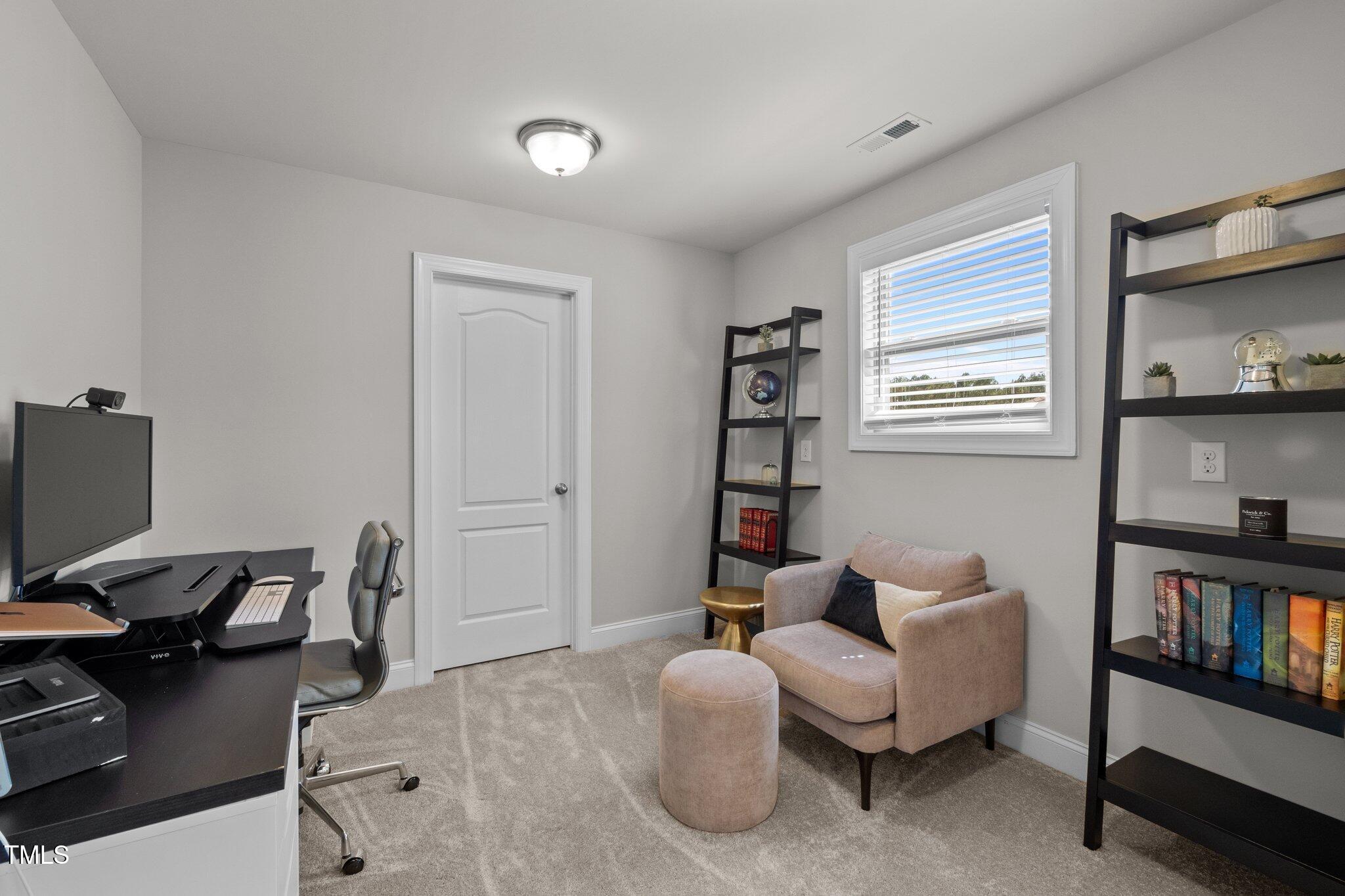 212 Crisp Road Durham, NC 27713 - Photo 27 of 36 a livingroom with workspace and a couch