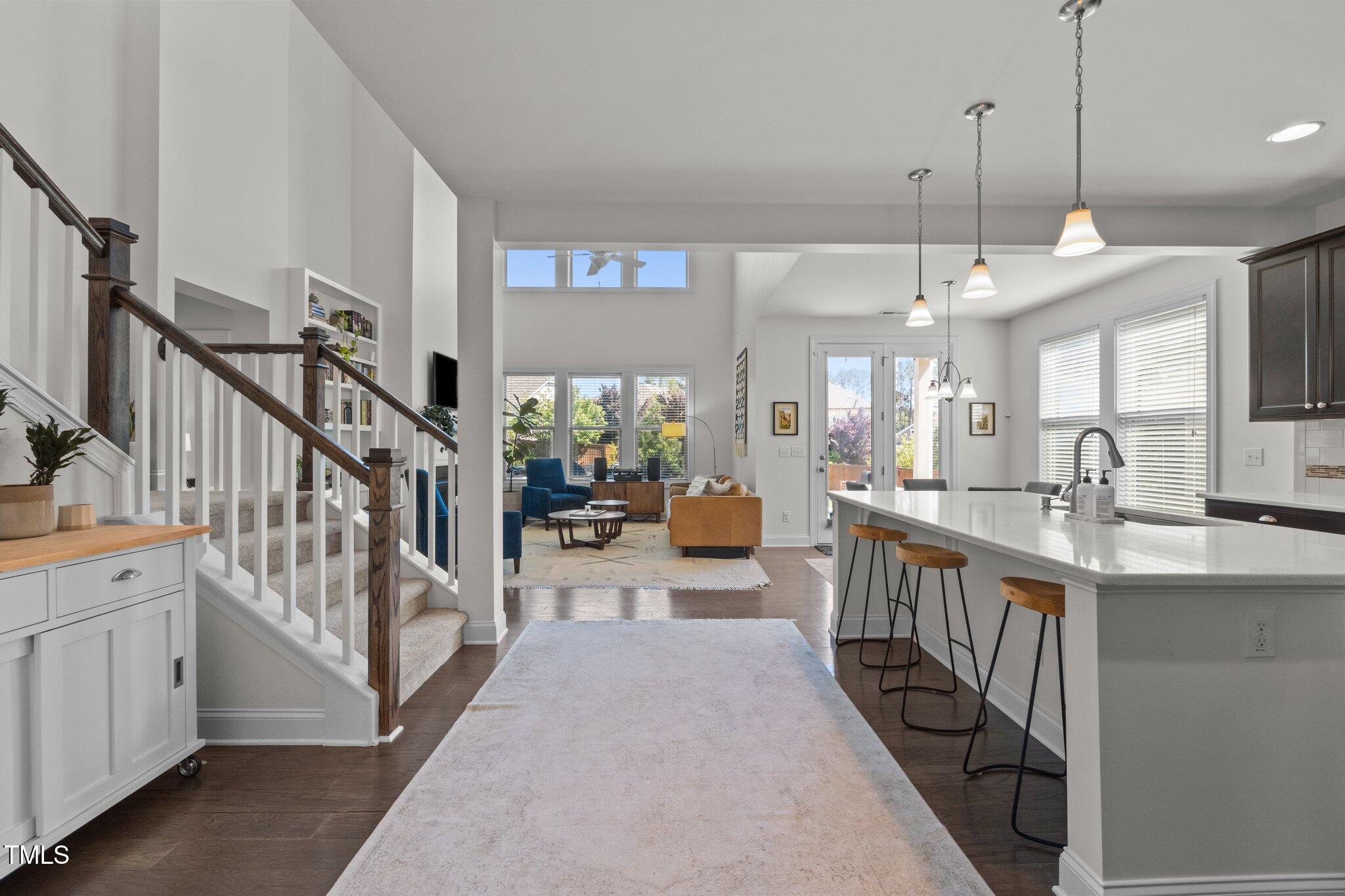 212 Crisp Road Durham, NC 27713 - Photo 5 of 36 a large white kitchen with lots of counter space a sink a window and chairs
