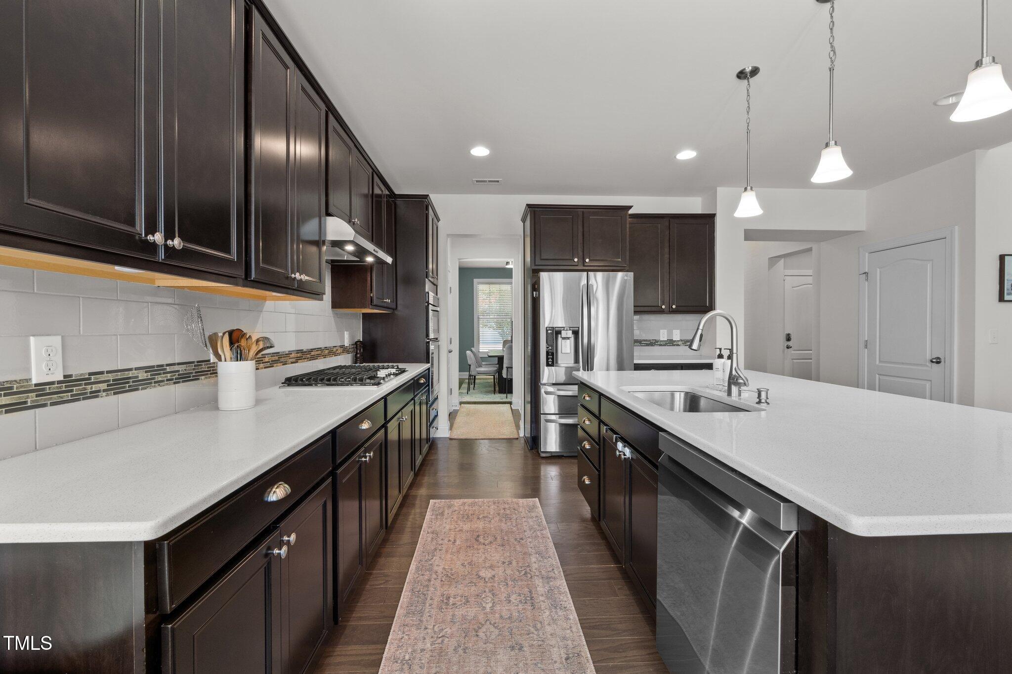 212 Crisp Road Durham, NC 27713 - Photo 8 of 36 a kitchen with lots of counter space a sink appliances and cabinets