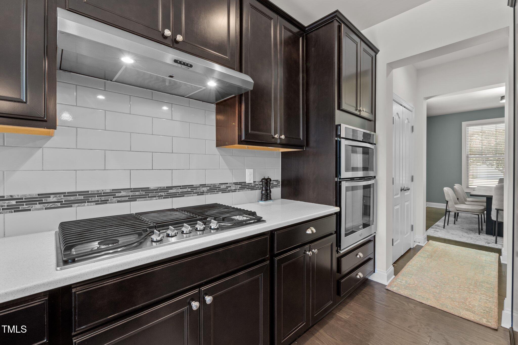 212 Crisp Road Durham, NC 27713 - Photo 9 of 36 a kitchen with a stove and a refrigerator