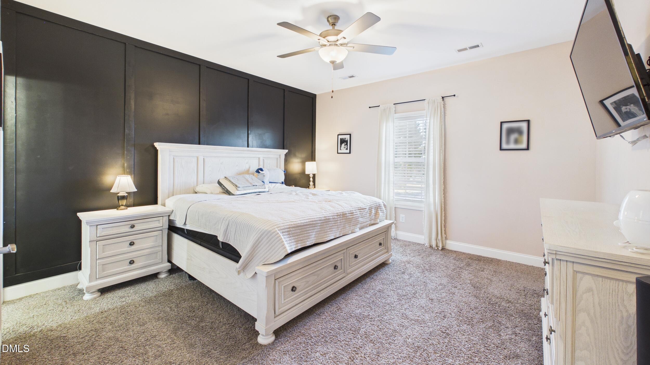 5930 Old 421 Road Liberty, NC 27298 - Photo 16 of 42 a bedroom with a bed and a chandelier
