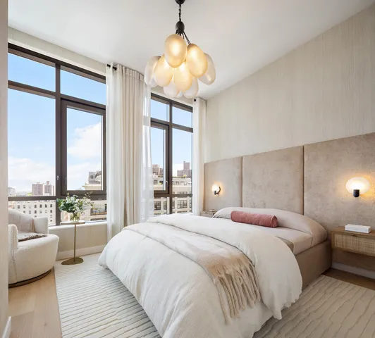 a bedroom with a large bed and a large window