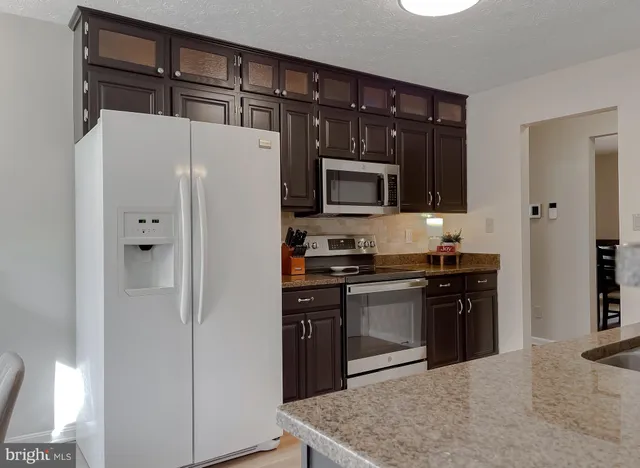 a bathroom with a granite countertop double vanity and a mirror