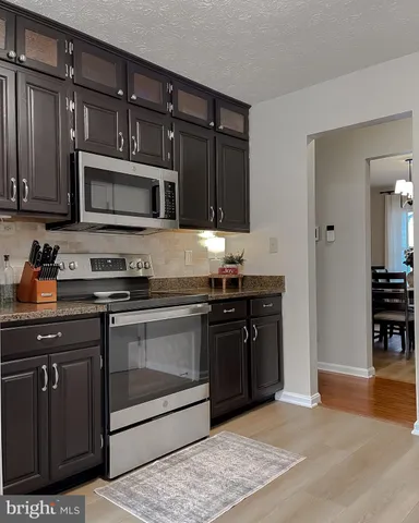 a spacious bedroom with a bed and a flat screen tv