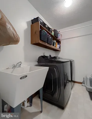 a living room with flat screen tv and a fireplace