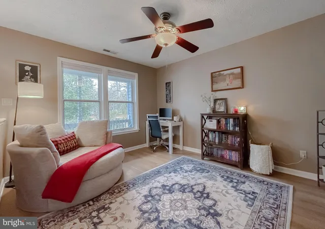 a bed room with a bed and a chair