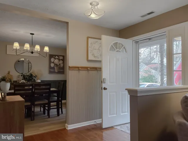 a view of a workspace room with wooden floor windows and cabinet