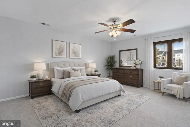 a bedroom with a bed and ceiling fan