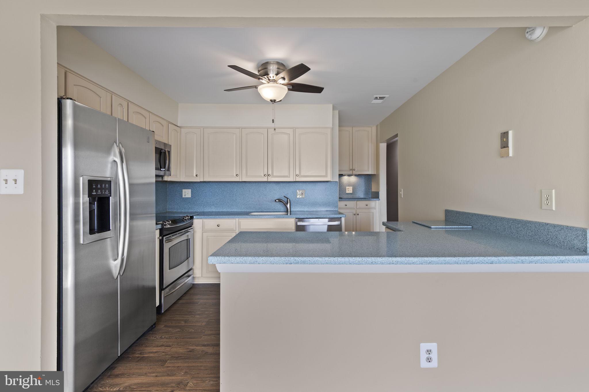 546 Riviera Drive, Unit 546B Joppa, MD 21085 - Photo 6 of 30 a kitchen with stainless steel appliances granite countertop a sink a refrigerator a washer and dryer