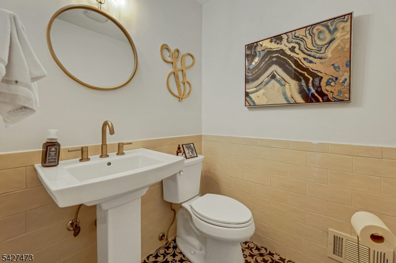 100 Easedale Road, Unit 100 Wayne, NJ 07470 - Photo 27 of 43 a bathroom with a toilet sink and mirror