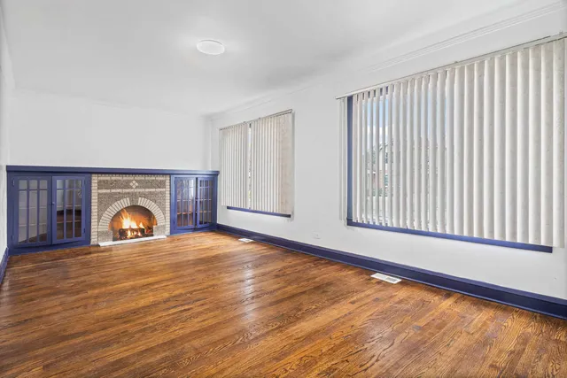 a view of a livingroom with a fireplace and wooden floor