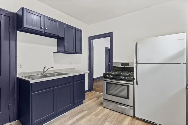 a kitchen with a sink and a refrigerator
