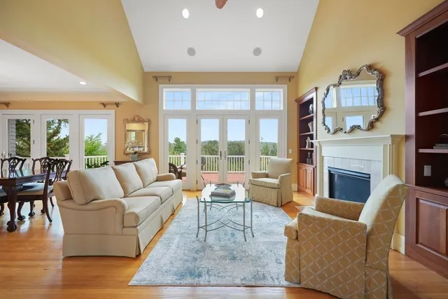 a living room with furniture a large window and a fireplace