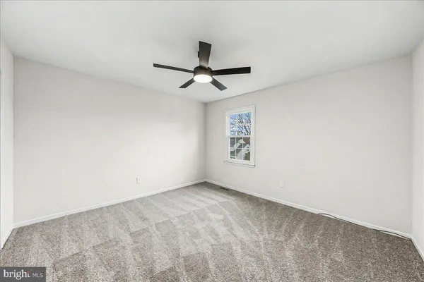 a view of room with a ceiling fan and window