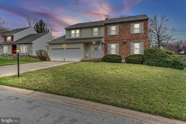 a view of a brick house with a yard